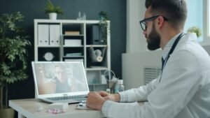 Doctor reviewing patient health data on a computer during an online medical consultation